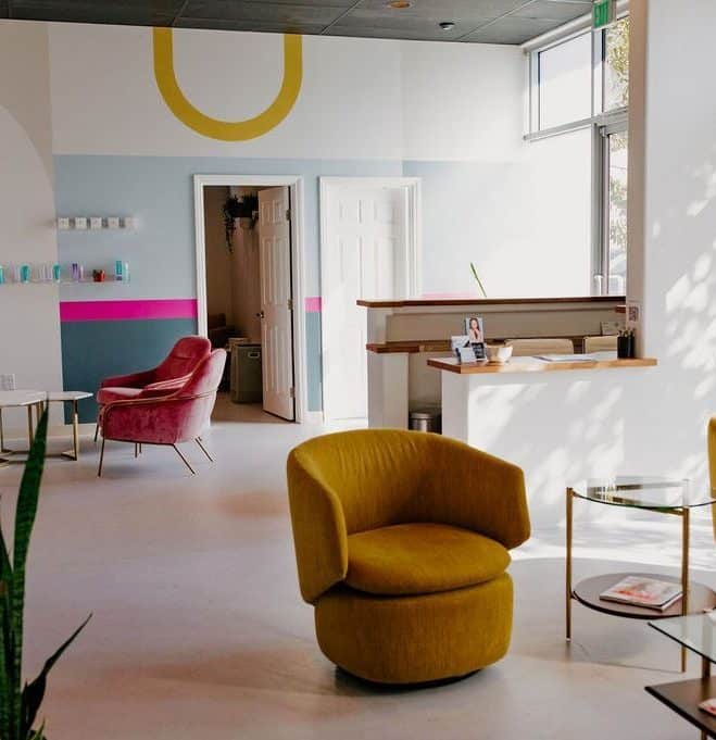 a living room filled with furniture and a large window